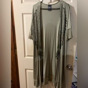 Vocal knee length shrug with angel wings.